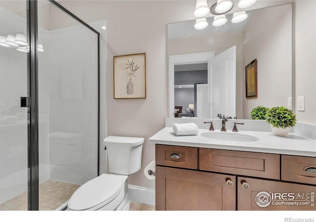 full bath featuring vanity, toilet, and a stall shower