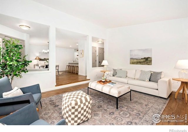 living room with baseboards and wood finished floors