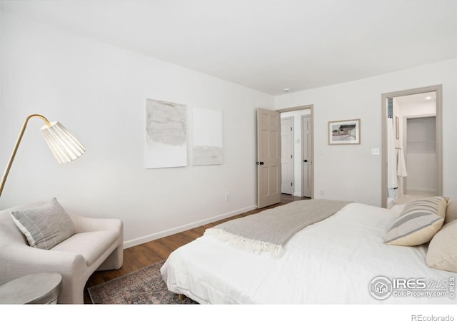 bedroom featuring baseboards and dark wood-style floors