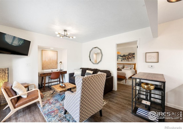 living room featuring baseboards, wood finished floors, and a notable chandelier