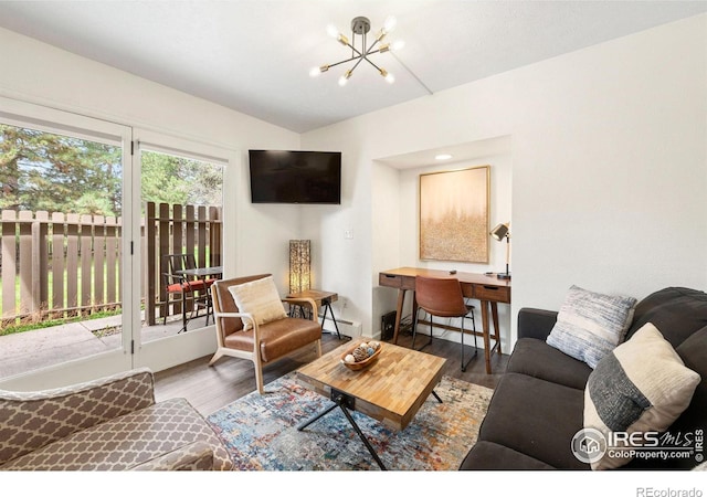 living area featuring a chandelier and wood finished floors