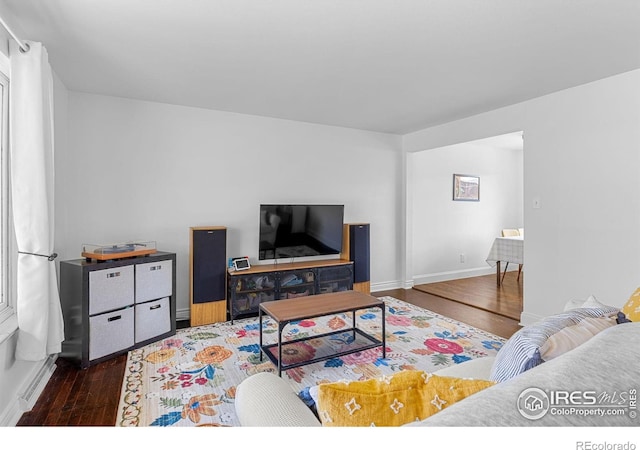 living room featuring baseboards and wood finished floors