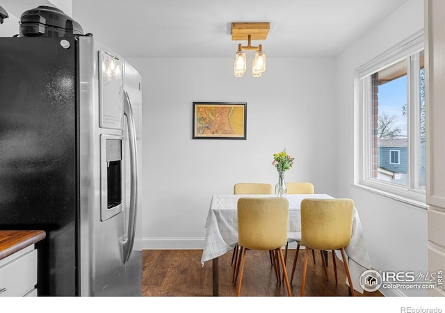 dining room with baseboards and wood finished floors