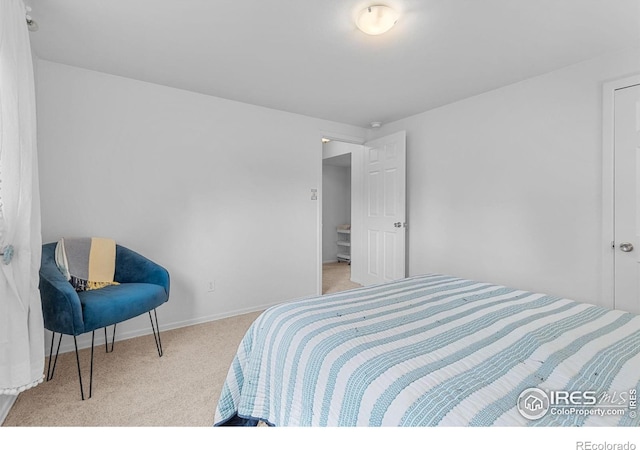 carpeted bedroom featuring baseboards