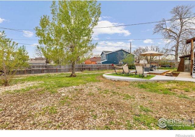 view of yard with fence and a patio area