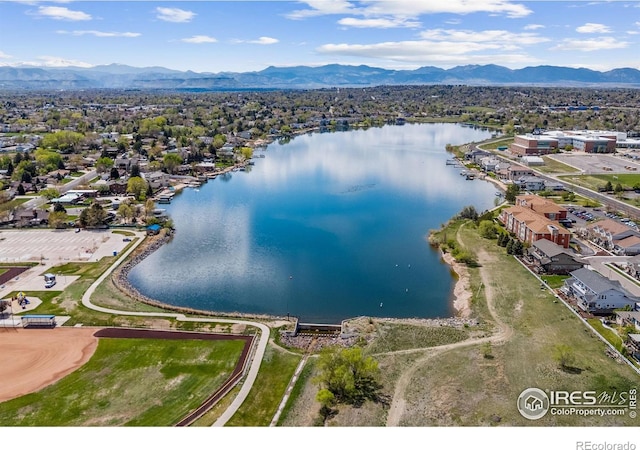 drone / aerial view featuring a water and mountain view and a residential view