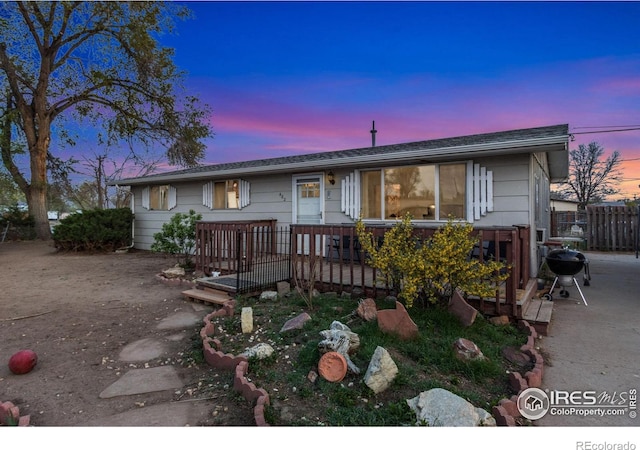 single story home with fence