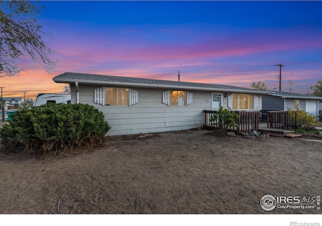 single story home with a wooden deck