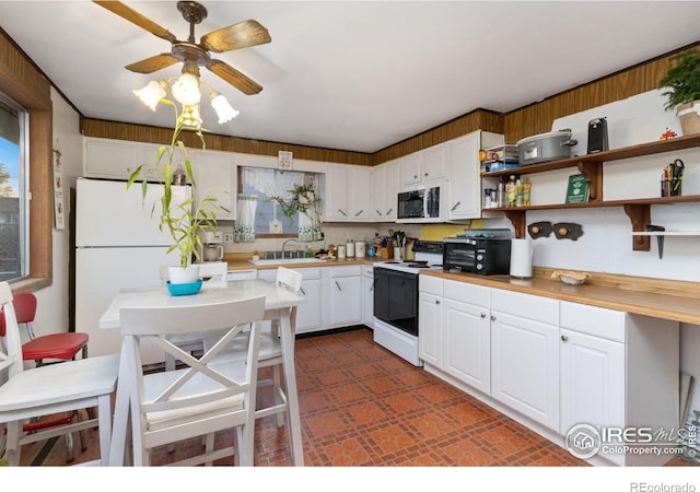 kitchen with open shelves, white appliances, light countertops, white cabinets, and a sink