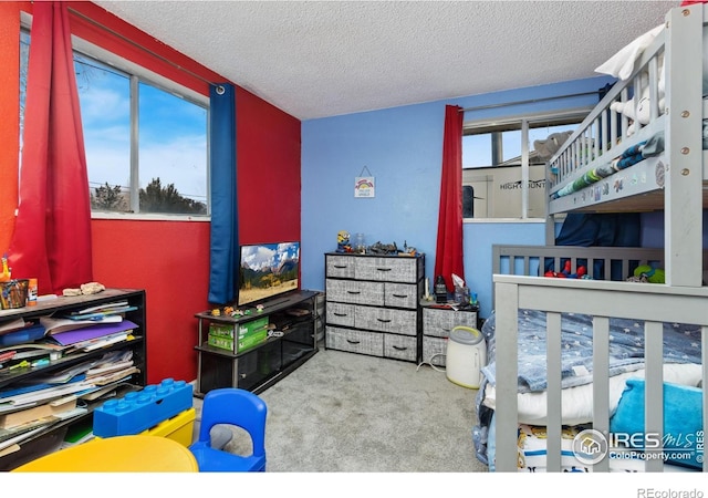 bedroom featuring a textured ceiling and carpet