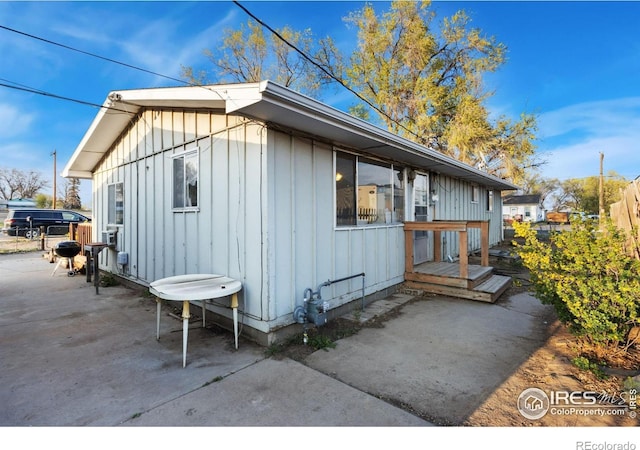 view of home's exterior featuring fence, a patio, and board and batten siding