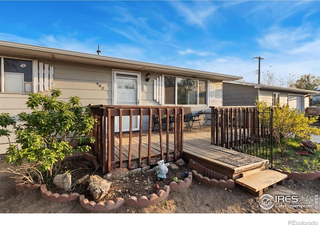 back of house with a wooden deck
