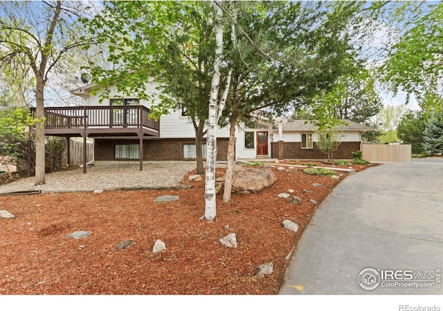 2617 Treemont Dr, Fort Collins, CO 80524 - view of front of house with brick siding and a wooden deck
