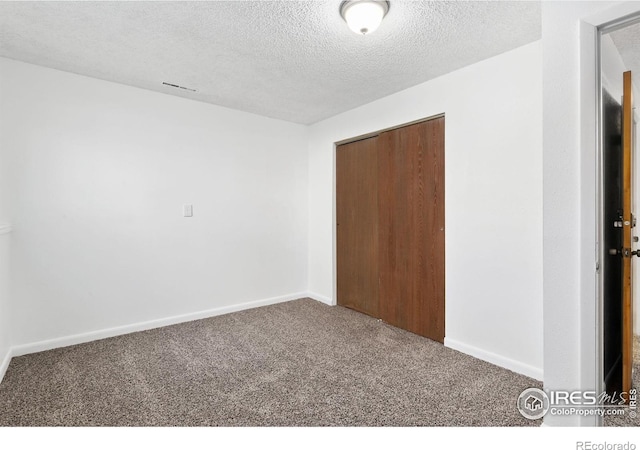 713 Boltz Dr, Fort Collins, CO 80525 - unfurnished bedroom with a closet, a textured ceiling, carpet, and baseboards