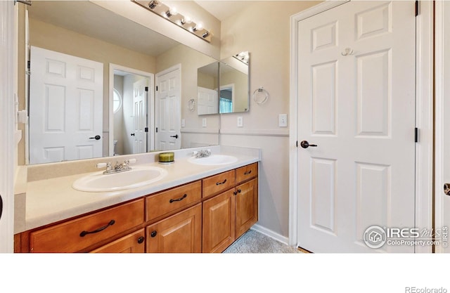 1442 Mallard Dr, Johnstown, CO 80534 - bathroom with double vanity, toilet, and baseboards