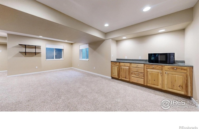 1442 Mallard Dr, Johnstown, CO 80534 - indoor wet bar with black microwave, light colored carpet, baseboards, and recessed lighting