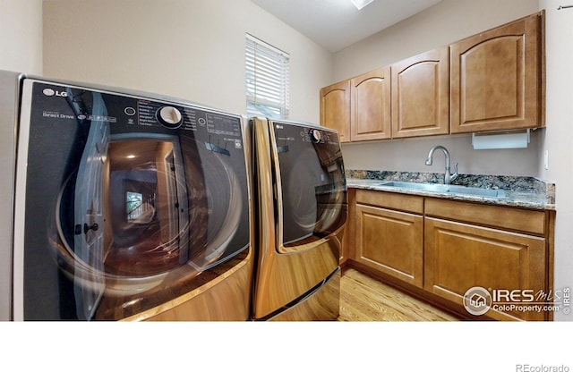 1442 Mallard Dr, Johnstown, CO 80534 - washroom featuring washer and dryer, cabinet space, and light wood finished floors