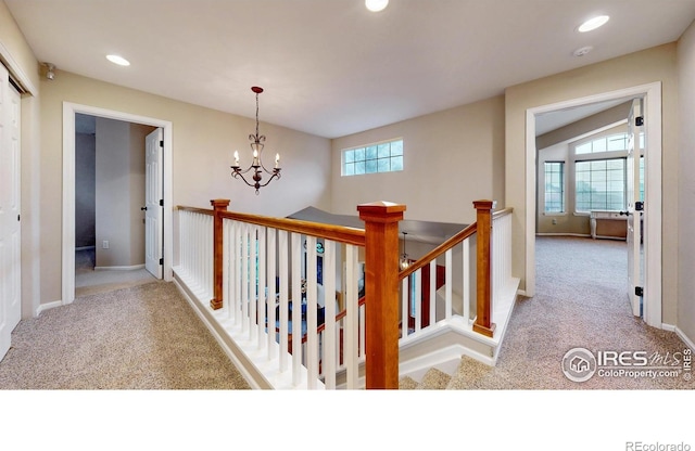1442 Mallard Dr, Johnstown, CO 80534 - hallway with carpet, a chandelier, baseboards, recessed lighting, and an upstairs landing