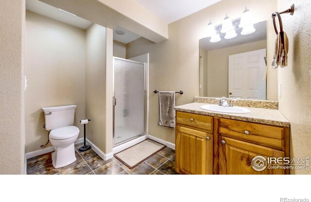 1442 Mallard Dr, Johnstown, CO 80534 - bathroom with a stall shower, toilet, vanity, and tile patterned flooring