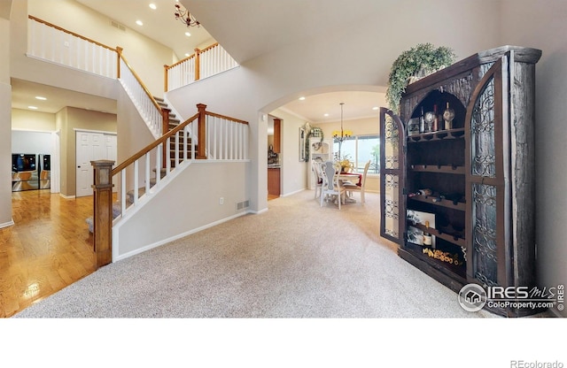 1442 Mallard Dr, Johnstown, CO 80534 - foyer entrance with arched walkways, carpet, recessed lighting, stairs, and baseboards