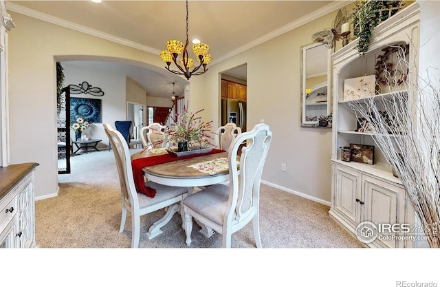 1442 Mallard Dr, Johnstown, CO 80534 - dining area featuring light colored carpet, a chandelier, arched walkways, crown molding, and baseboards
