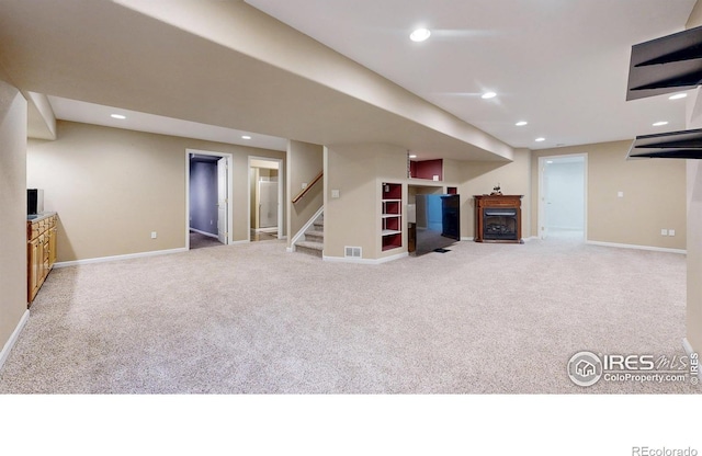 1442 Mallard Dr, Johnstown, CO 80534 - finished below grade area with carpet floors, a fireplace, stairway, baseboards, and recessed lighting