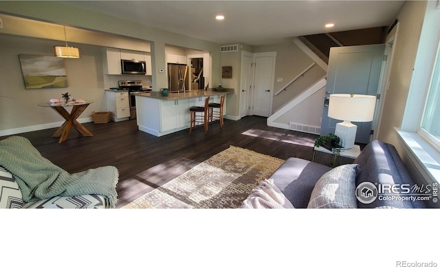 1180 Monroe Dr Unit C, Boulder, CO 80303 - living area with dark wood finished floors, stairs, baseboards, and recessed lighting