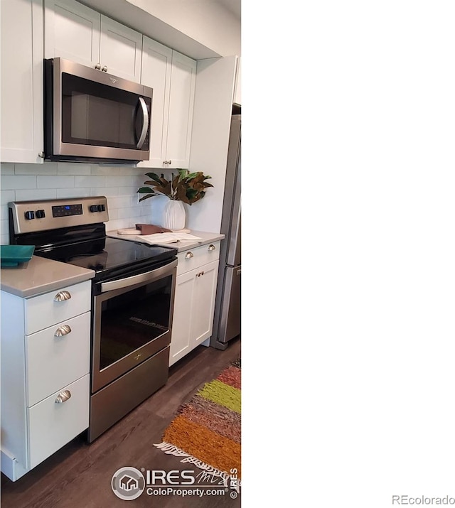 1180 Monroe Dr Unit C, Boulder, CO 80303 - kitchen with stainless steel appliances, dark wood finished floors, white cabinetry, light countertops, and backsplash