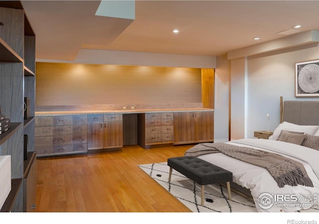bedroom with light wood-style floors and recessed lighting