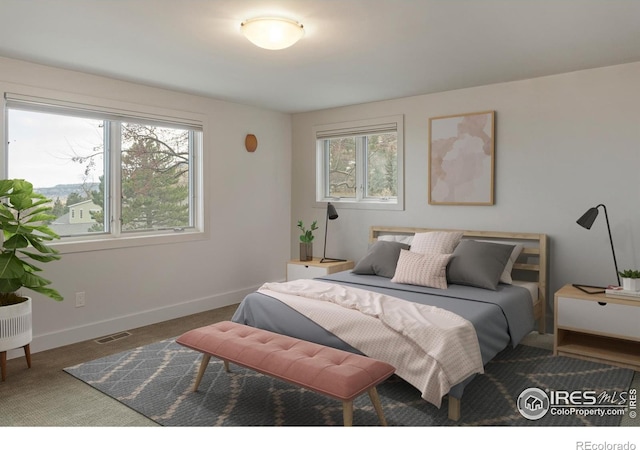 carpeted bedroom featuring visible vents and baseboards