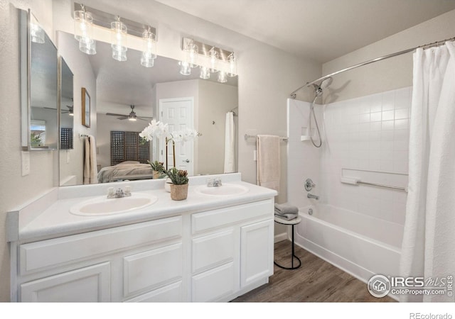 ensuite bathroom with a sink, a ceiling fan, wood finished floors, and connected bathroom