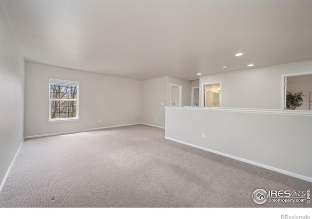 spare room featuring baseboards, recessed lighting, and carpet