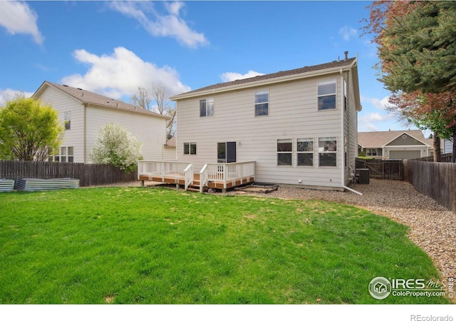 rear view of house with a fenced backyard, central AC, a yard, and a deck