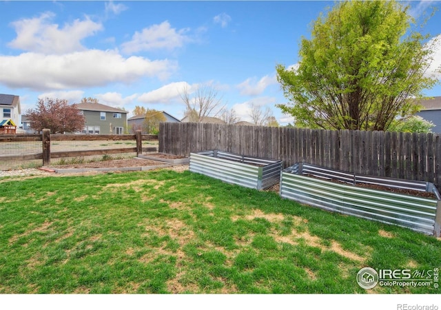 view of yard with a garden and fence