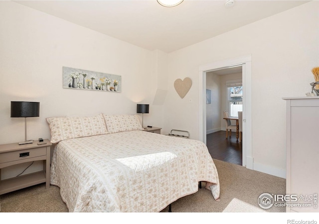 carpeted bedroom featuring baseboards