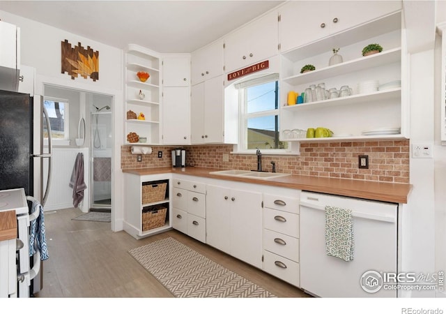 kitchen with open shelves, a sink, white appliances, and white cabinetry