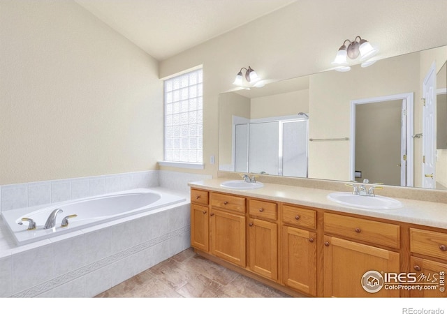bathroom featuring double vanity, a sink, and a garden tub