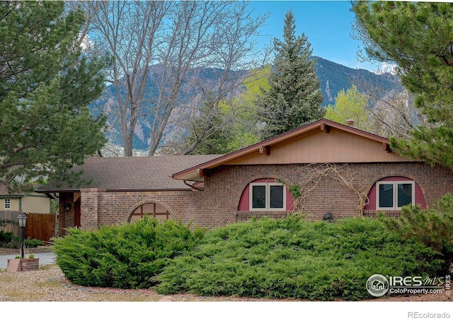 285 Hopi Pl, Boulder, CO 80303 - view of front of home with brick siding, a mountain view, and roof with shingles