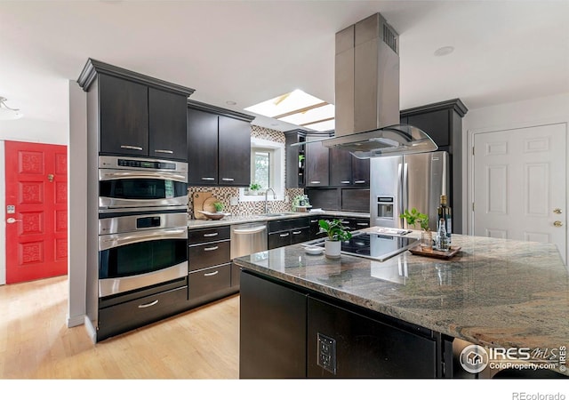 285 Hopi Pl, Boulder, CO 80303 - kitchen with island range hood, light wood-style floors, stainless steel appliances, and a sink