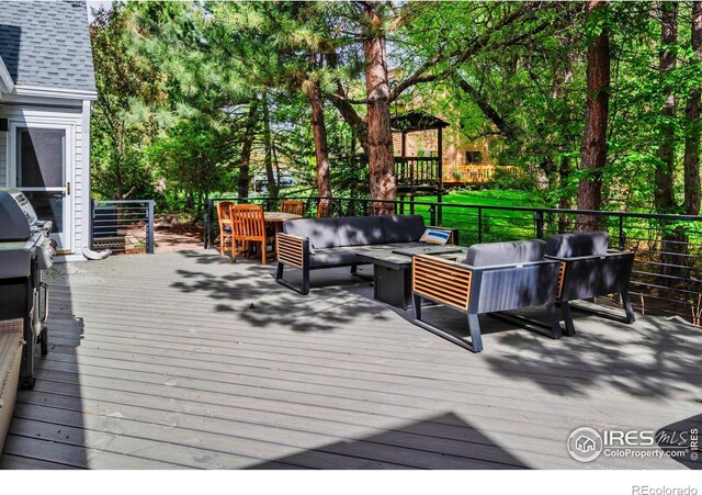 2672 Winding Trail Dr, Boulder, CO 80304 - wooden deck with an outdoor living space and view of wooded area