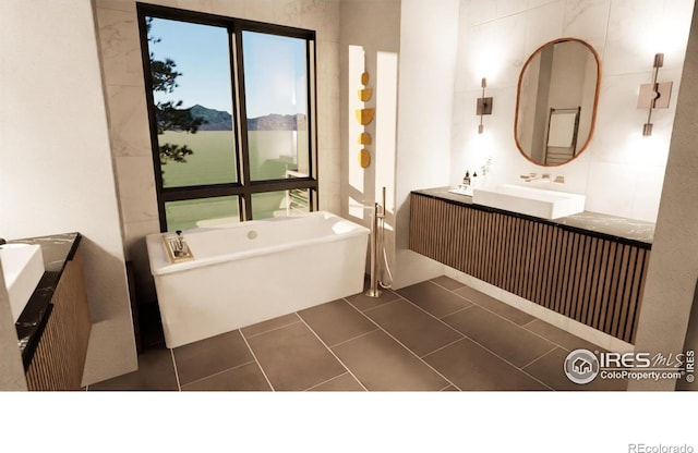 bathroom featuring vanity, tile patterned flooring, and a freestanding bath