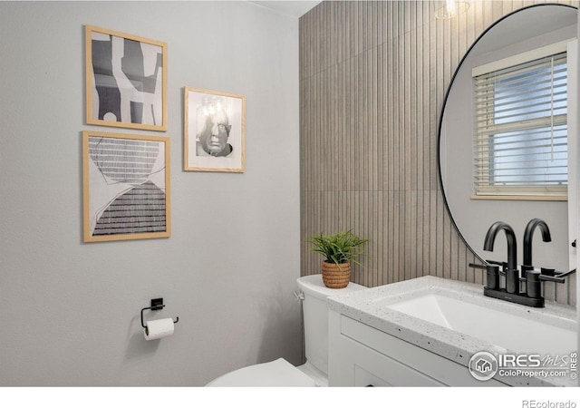 bathroom featuring toilet and vanity
