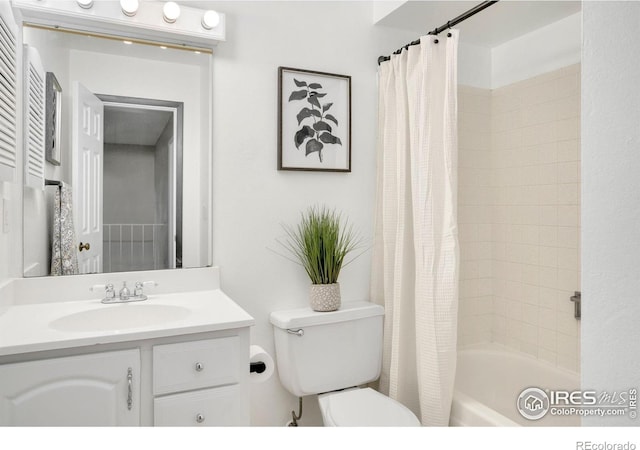 full bath with vanity, shower / bath combo with shower curtain, and toilet