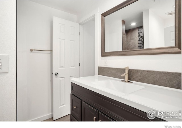 bathroom with vanity, recessed lighting, and visible vents