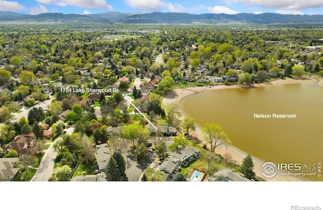 aerial view with a water and mountain view and a residential view