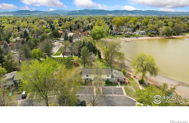 drone / aerial view with a water and mountain view