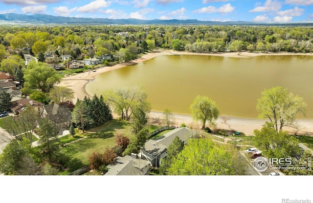 bird's eye view featuring a water and mountain view and a wooded view