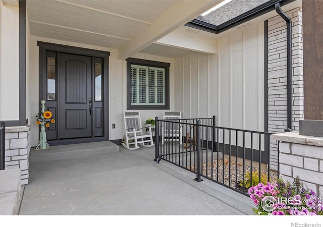 1603 Plank Ln, Fort Collins, CO 80524 - doorway to property with a porch, board and batten siding, and roof with shingles