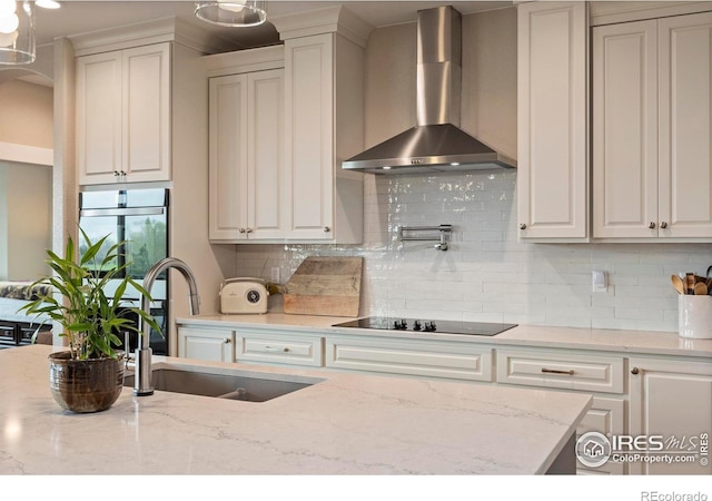 1603 Plank Ln, Fort Collins, CO 80524 - kitchen with black electric cooktop, a sink, wall chimney exhaust hood, and decorative backsplash