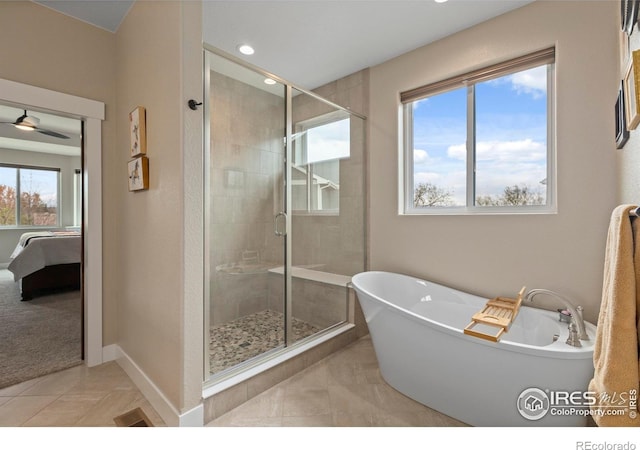 1603 Plank Ln, Fort Collins, CO 80524 - ensuite bathroom featuring a freestanding bath, tile patterned flooring, a stall shower, baseboards, and connected bathroom